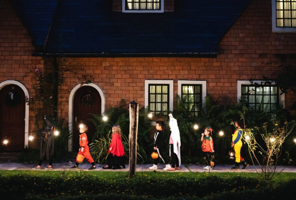 children trick and treating at halloween night