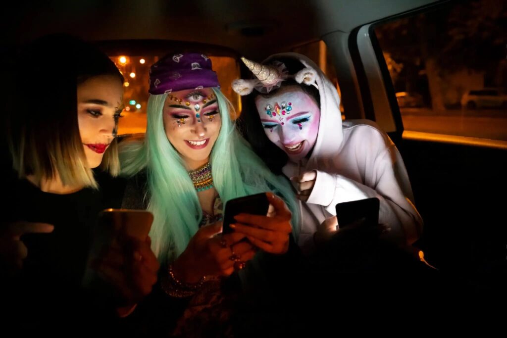 three disguised girls in a car, heading to their halloween party